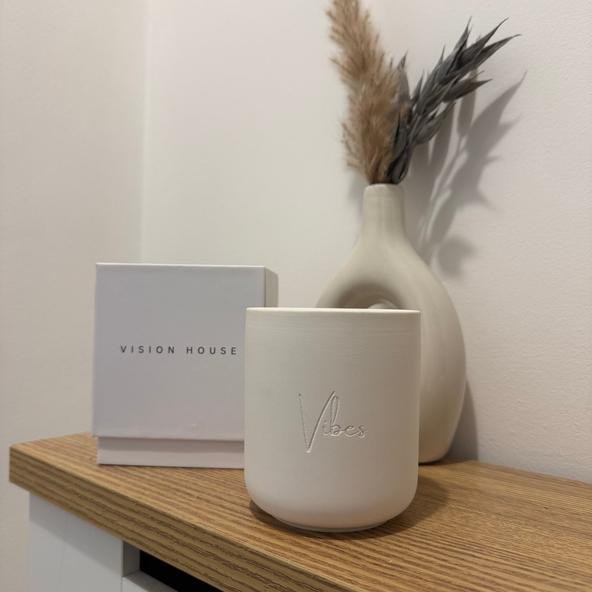 Ceramic wick candle with 'Vision House' branding